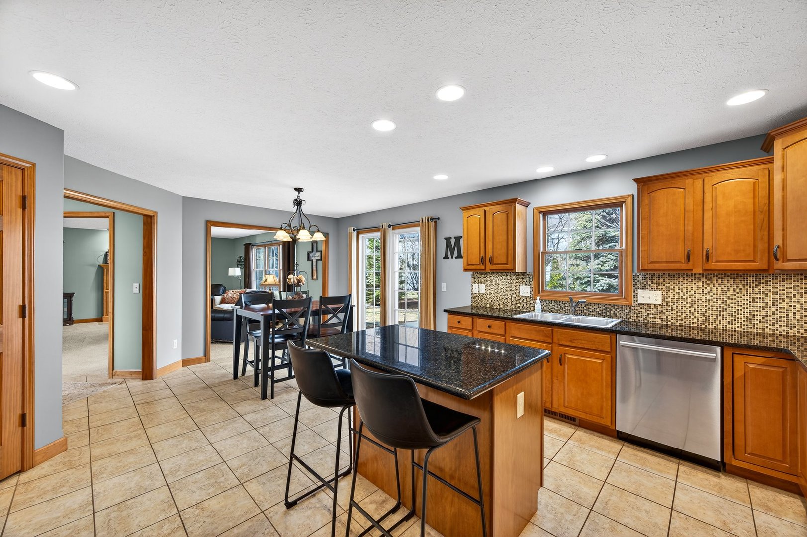 2968 Wolf Creek Lane Normal, IL 61761 - Photo 14 of 47 a dining hall with stainless steel appliances granite countertop a stove top oven a sink a dining table and chairs
