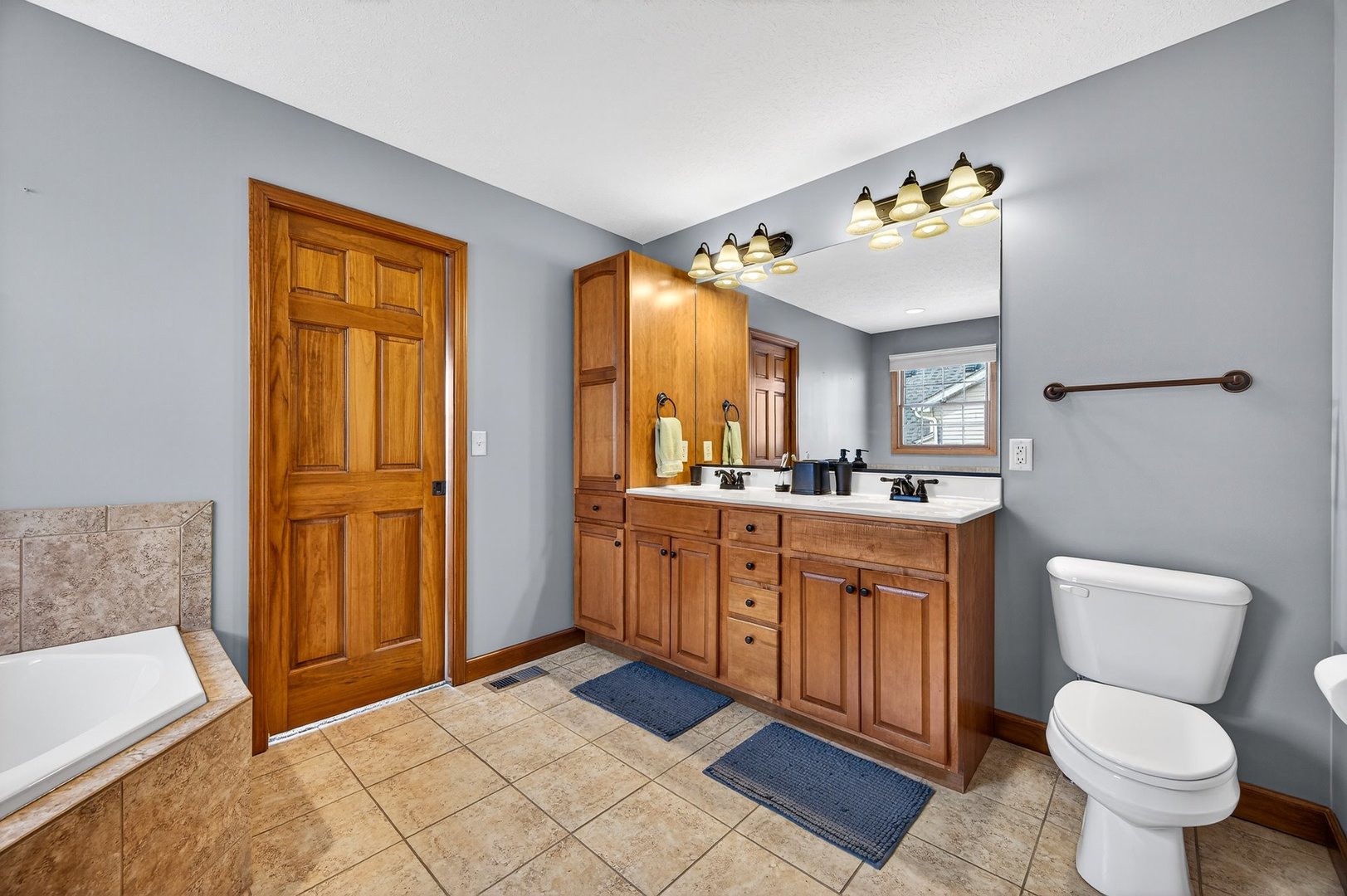 2968 Wolf Creek Lane Normal, IL 61761 - Photo 23 of 47 a spacious bathroom with a granite countertop toilet sink and mirror