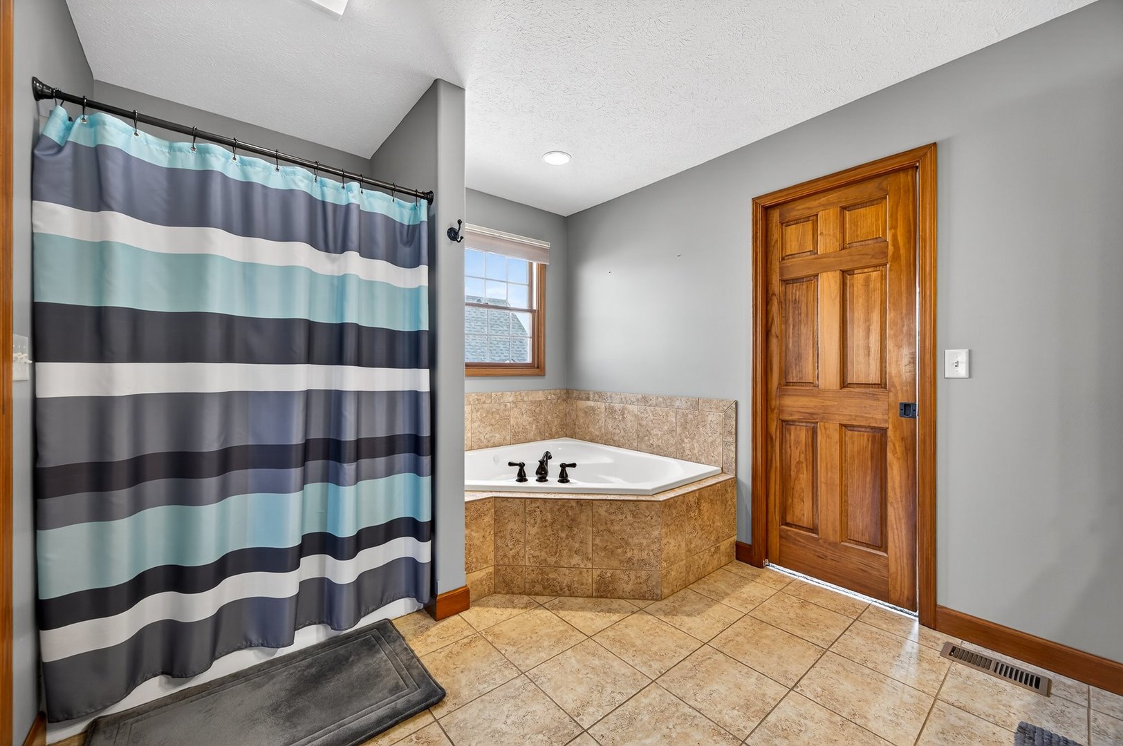 2968 Wolf Creek Lane Normal, IL 61761 - Photo 24 of 47 a bathroom with a bathtub and a shower