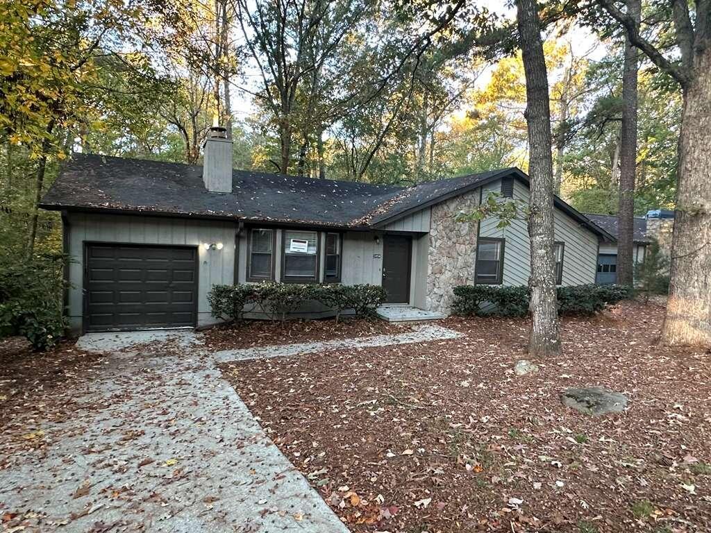 3956 Ferncliff Road Southwest Snellville, GA 30039 - Photo 1 of 1 a front view of a house with a garden