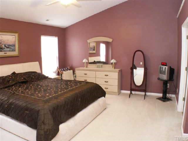 3624 Pritchard Court Raleigh, NC 27616 - Photo 11 of 12 a bedroom with a bed and a potted plant on dresser