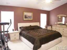 3624 Pritchard Court Raleigh, NC 27616 - Photo 3 of 12 a spacious bedroom with a bed and a lamp