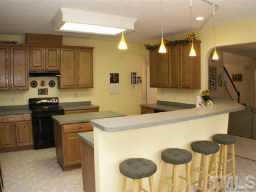 3624 Pritchard Court Raleigh, NC 27616 - Photo 4 of 12 a kitchen with a sink stainless steel appliances and cabinets