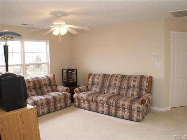 3624 Pritchard Court Raleigh, NC 27616 - Photo 8 of 12 a living room with furniture and a large window