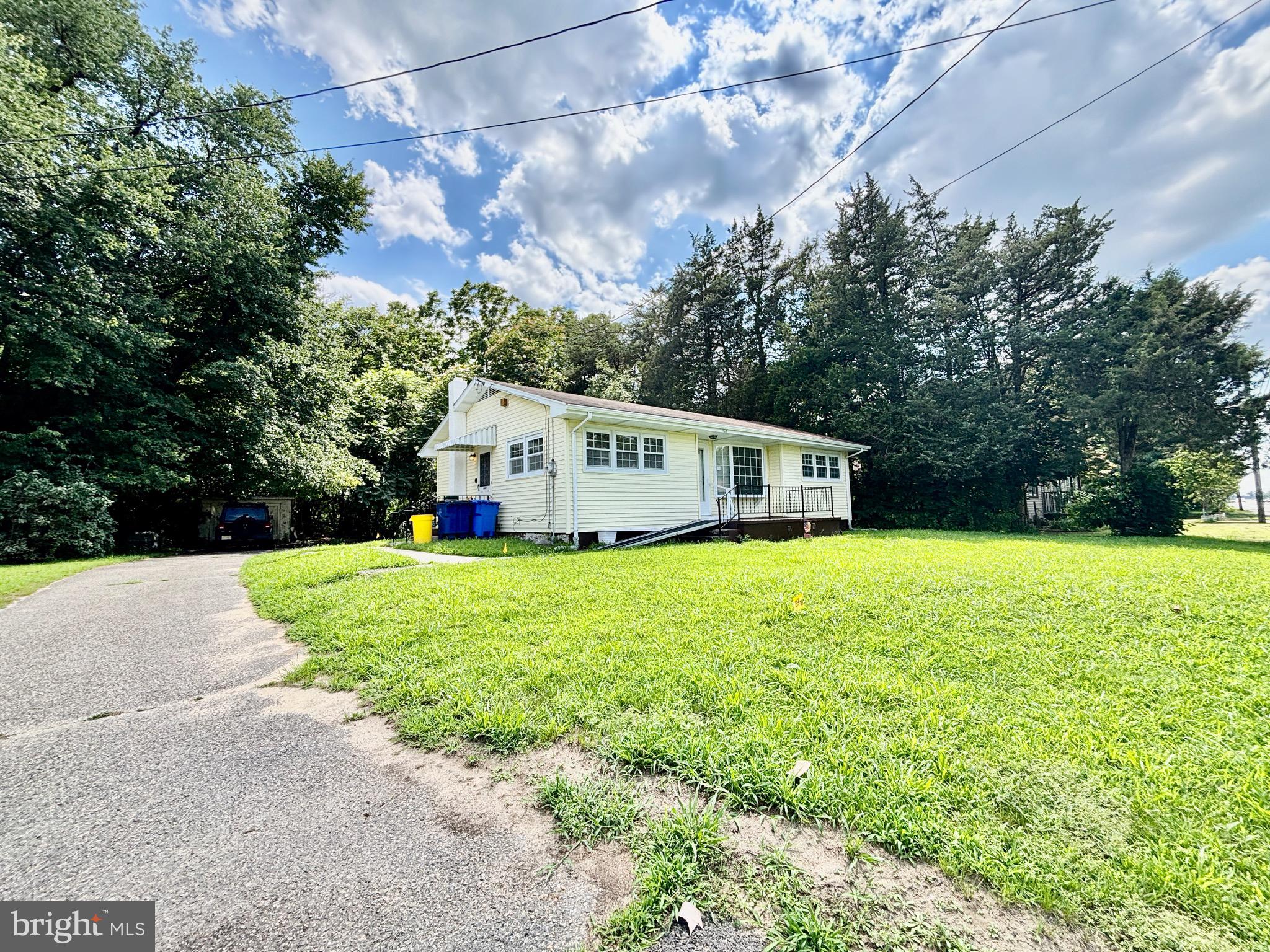 123 South Pemberton Road Pemberton, NJ 08068 - Photo 2 of 16 a front view of house with yard and trees all around
