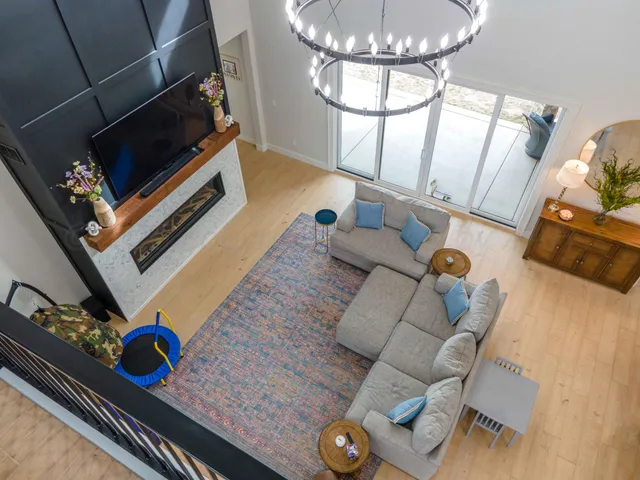 a living room with furniture and a chandelier