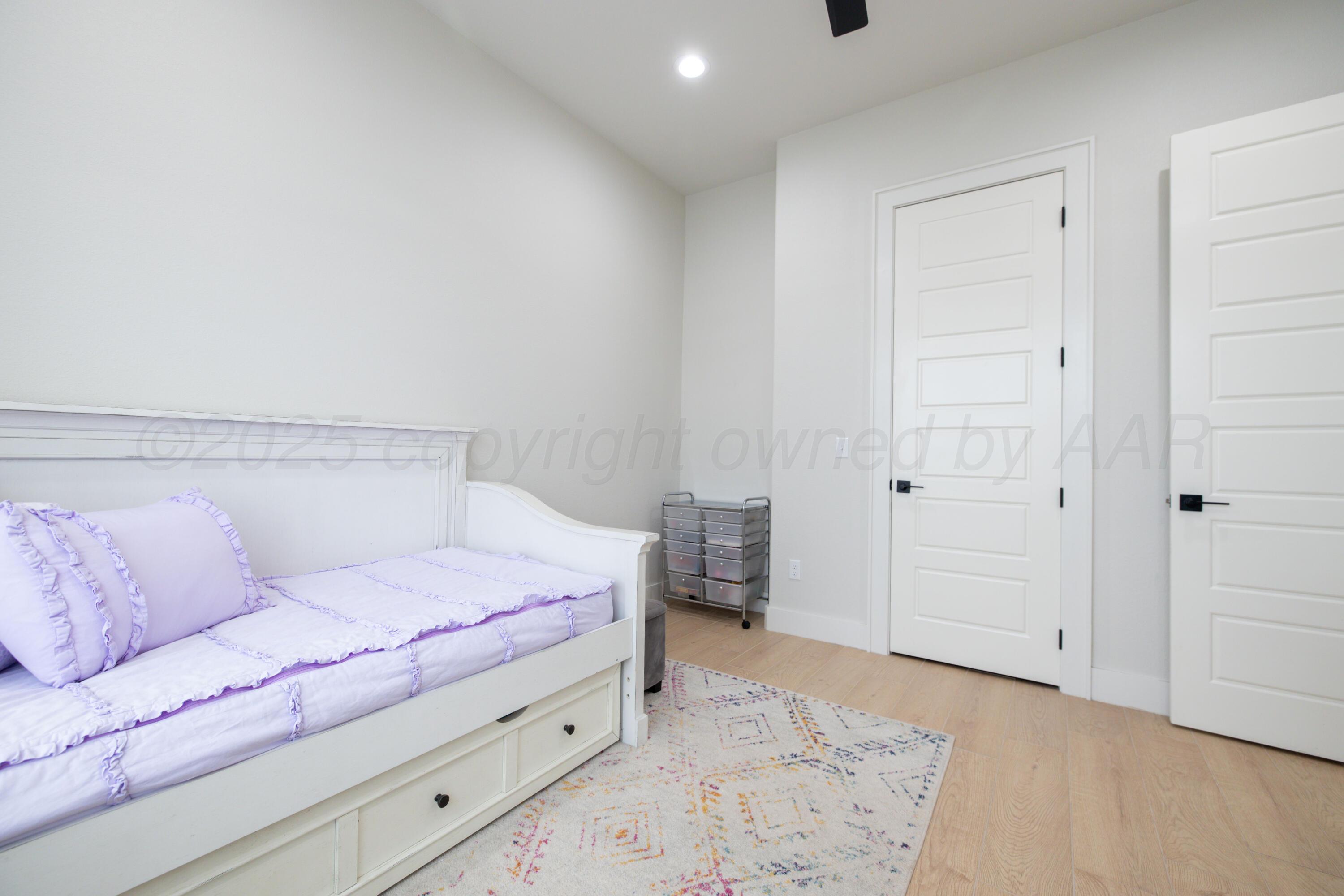 9507 Meadow Ridge Amarillo, TX 79118 - Photo 16 of 56 a bedroom with a bed and a couch