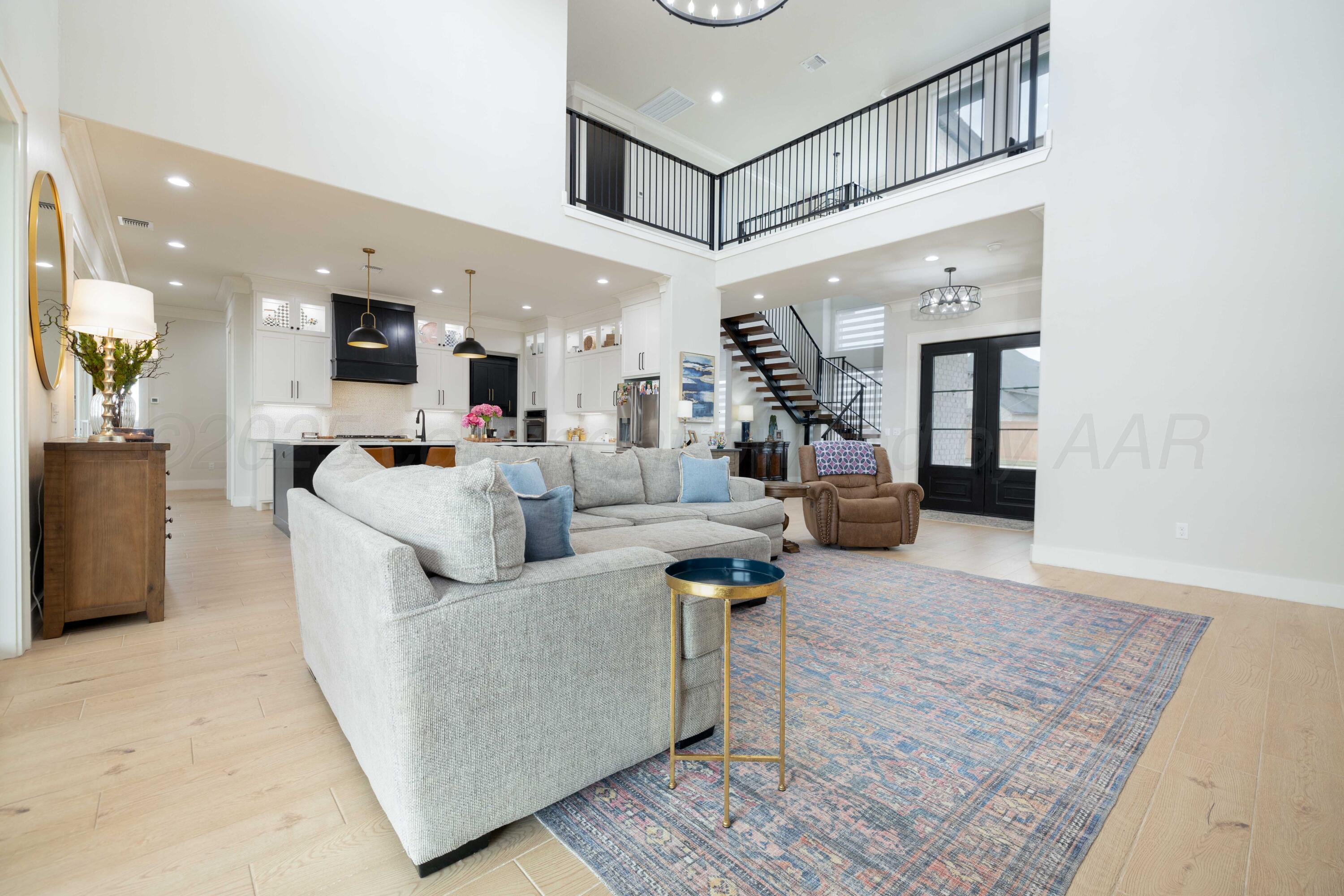 9507 Meadow Ridge Amarillo, TX 79118 - Photo 21 of 56 a living room with furniture and a chandelier