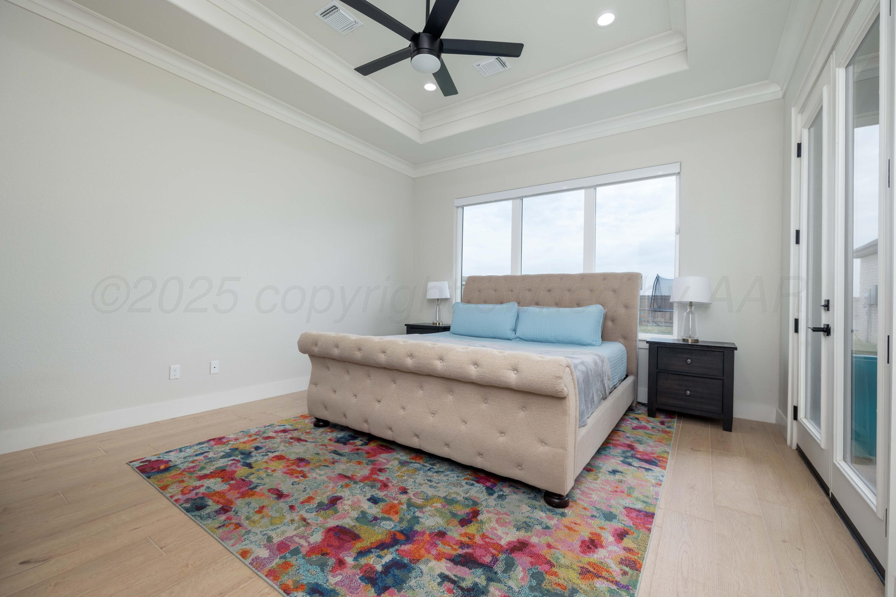 9507 Meadow Ridge Amarillo, TX 79118 - Photo 41 of 56 a bedroom with a bed dresser and a window