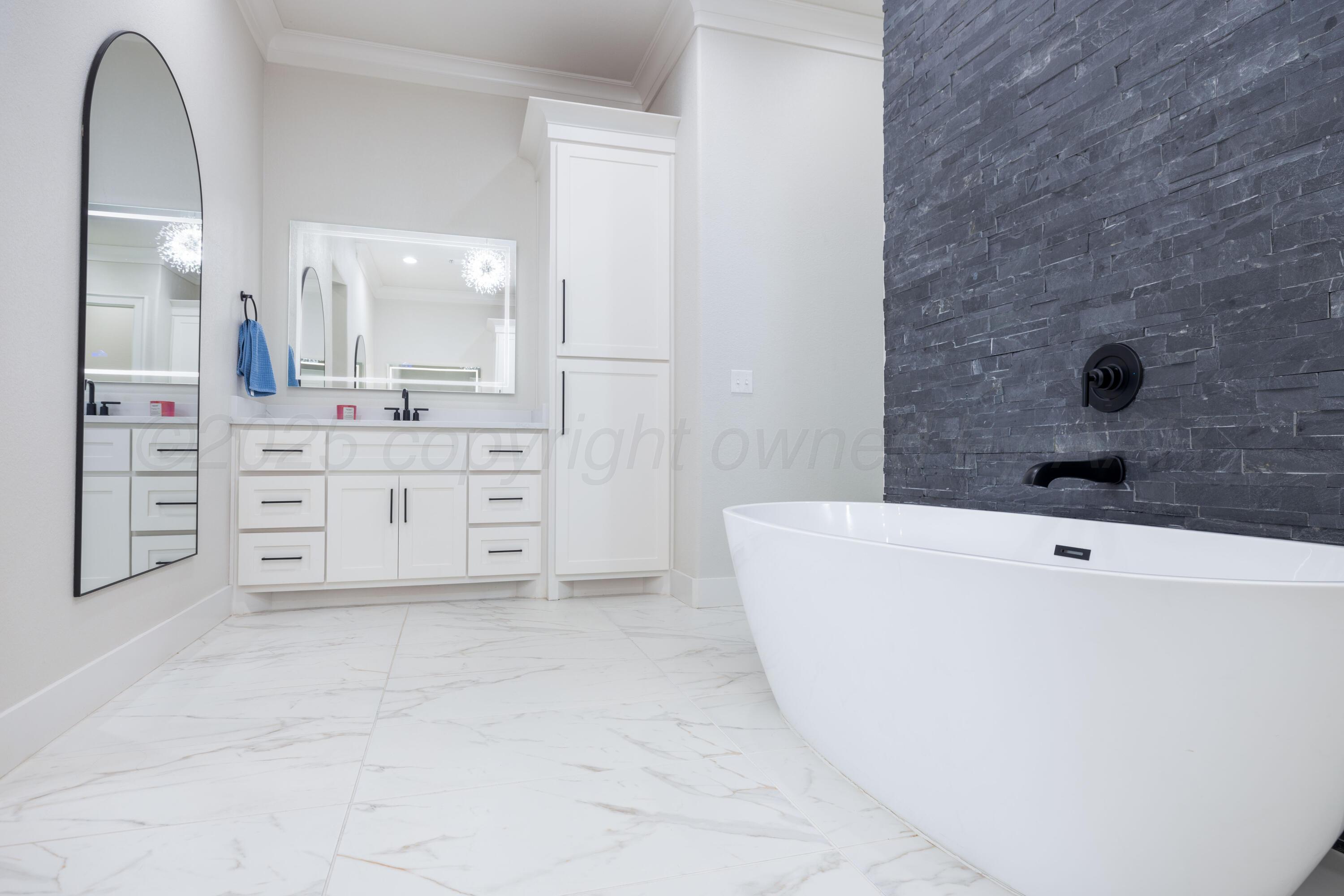 9507 Meadow Ridge Amarillo, TX 79118 - Photo 49 of 56 a spacious bathroom with a tub sink and mirror