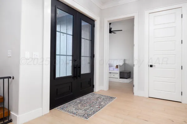 a view of entryway and hall with wooden floor