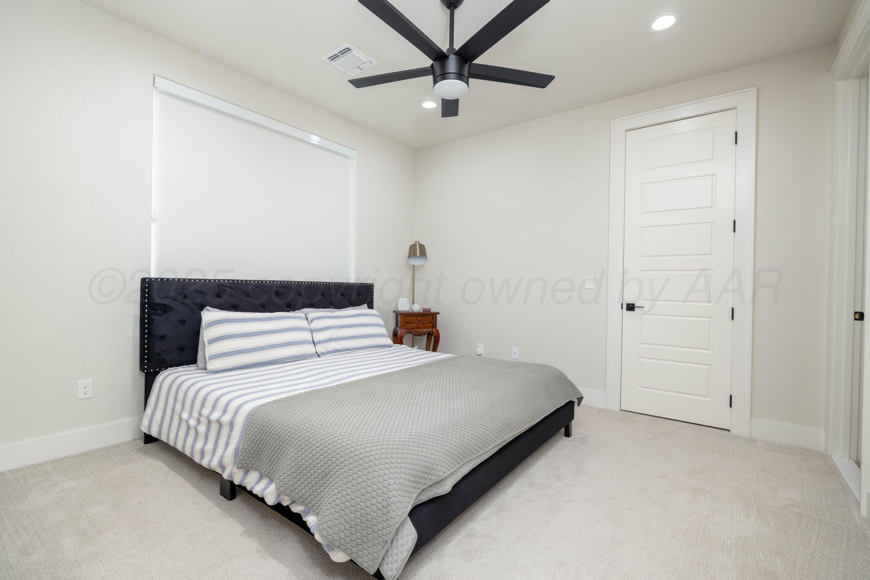 9507 Meadow Ridge Amarillo, TX 79118 - Photo 52 of 56 a bedroom with a bed and a ceiling fan