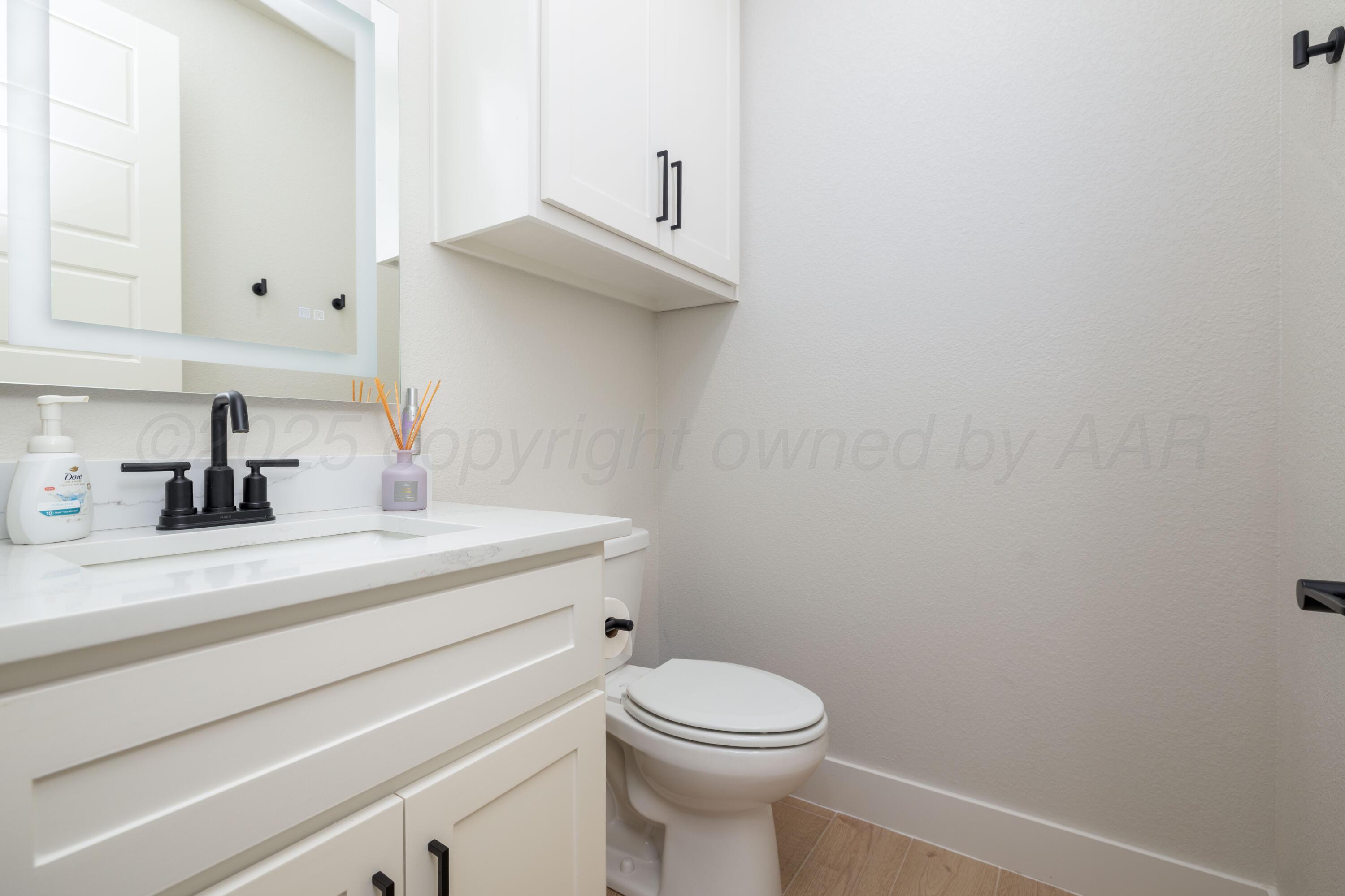 9507 Meadow Ridge Amarillo, TX 79118 - Photo 53 of 56 a bathroom with a sink a toilet and mirror