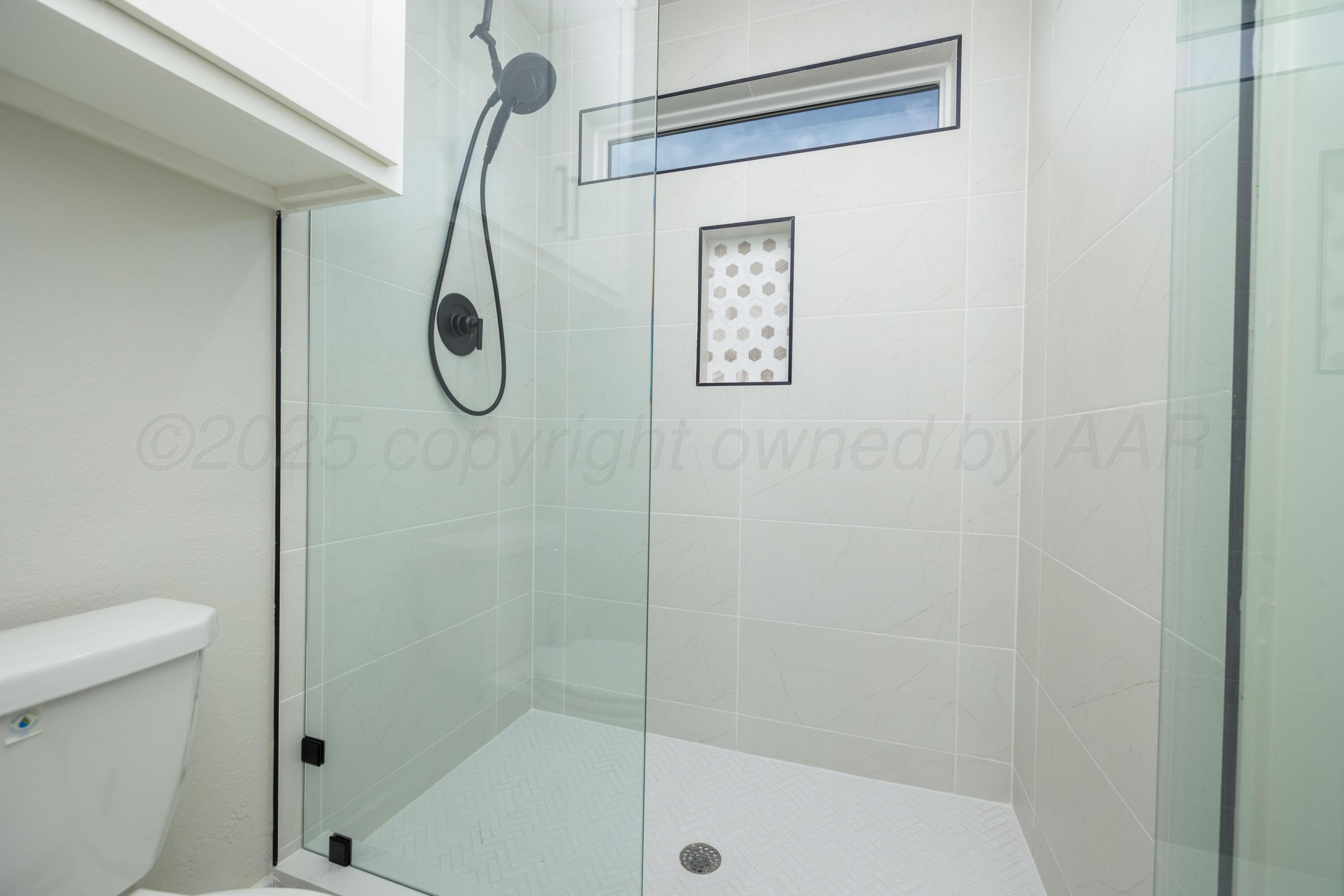 9507 Meadow Ridge Amarillo, TX 79118 - Photo 56 of 56 a bathroom with a shower and a toilet