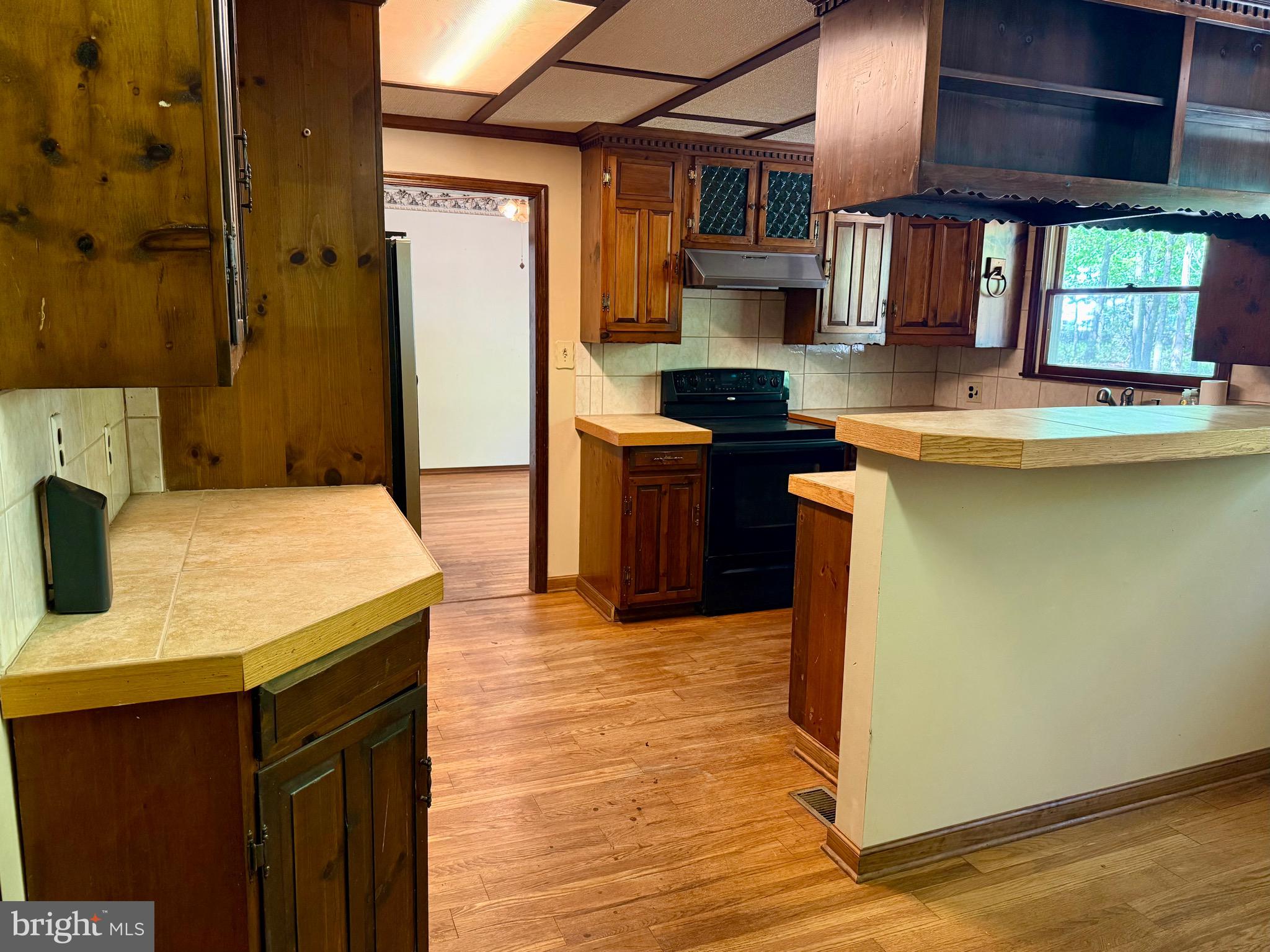 229 Oakshade Road Tabernacle, NJ 08088 - Photo 32 of 57 a kitchen with stainless steel appliances granite countertop a sink a stove counter space and cabinets