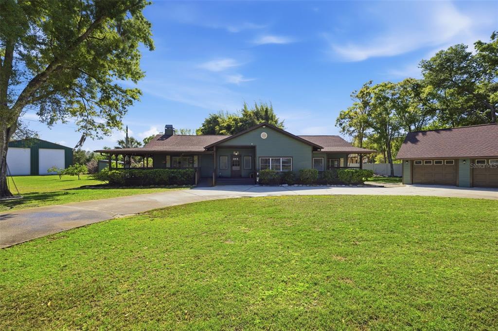 a front view of house with yard and green space