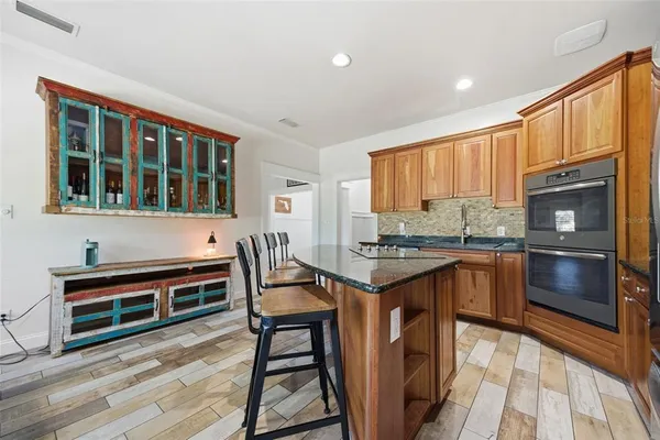 a spacious bedroom with a bed and cabinet