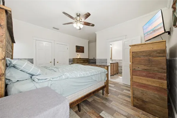 a bedroom with a bed and large windows