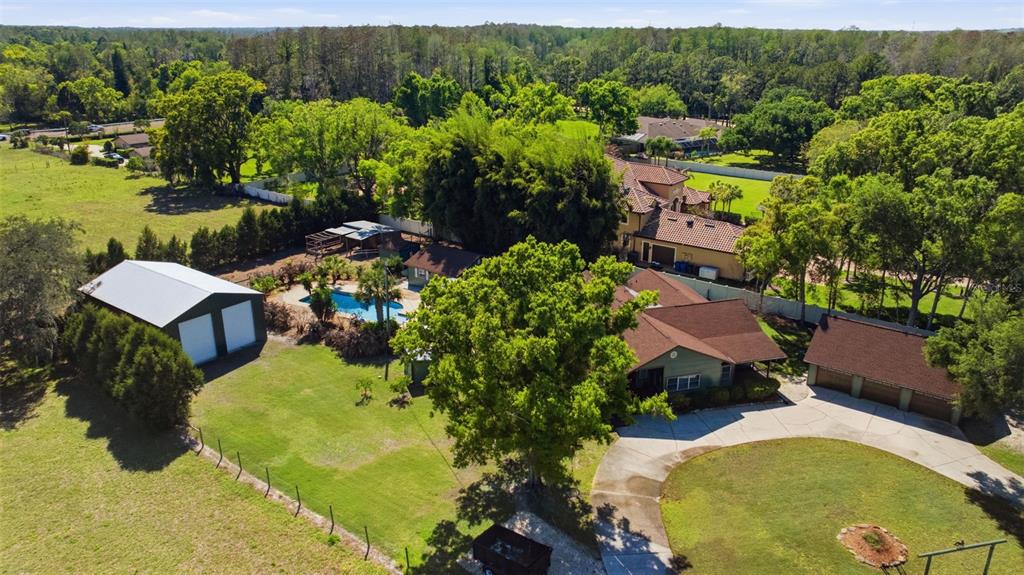 3752 Old Keystone Road Tarpon Springs, FL 34688 - Photo 2 of 71 an aerial view of a house with swimming pool and garden