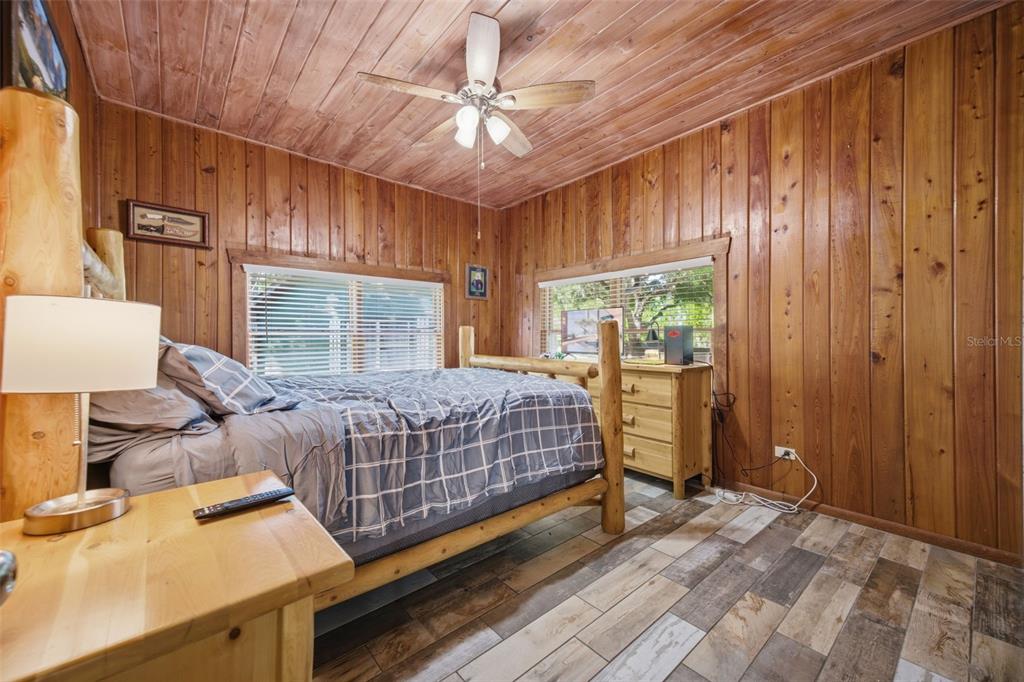 3752 Old Keystone Road Tarpon Springs, FL 34688 - Photo 28 of 71 a bedroom with a bed and large windows
