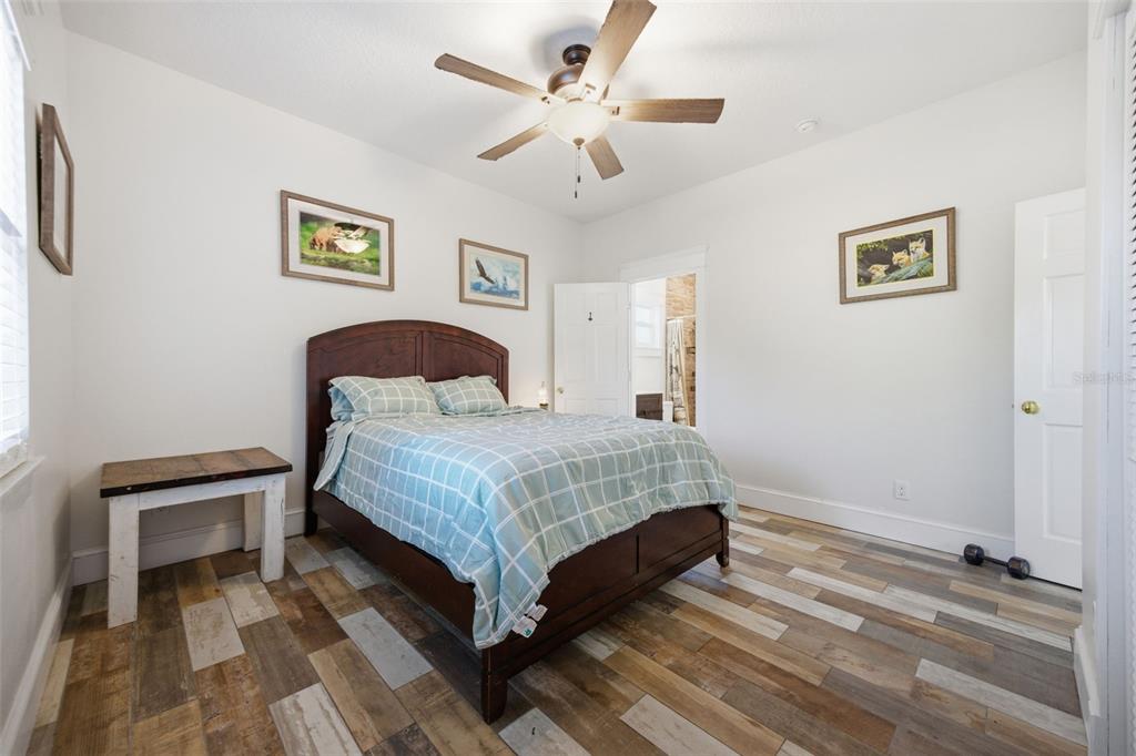 3752 Old Keystone Road Tarpon Springs, FL 34688 - Photo 32 of 71 a bedroom with a bed and a chandelier