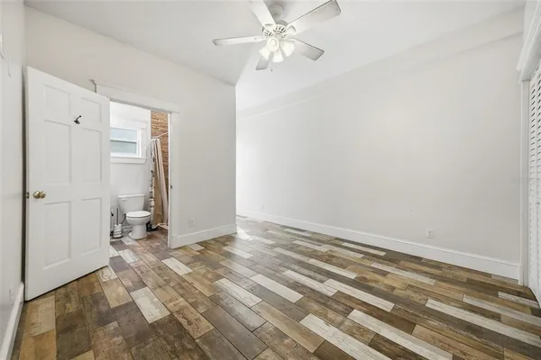 a dining room with furniture a window and wooden floor