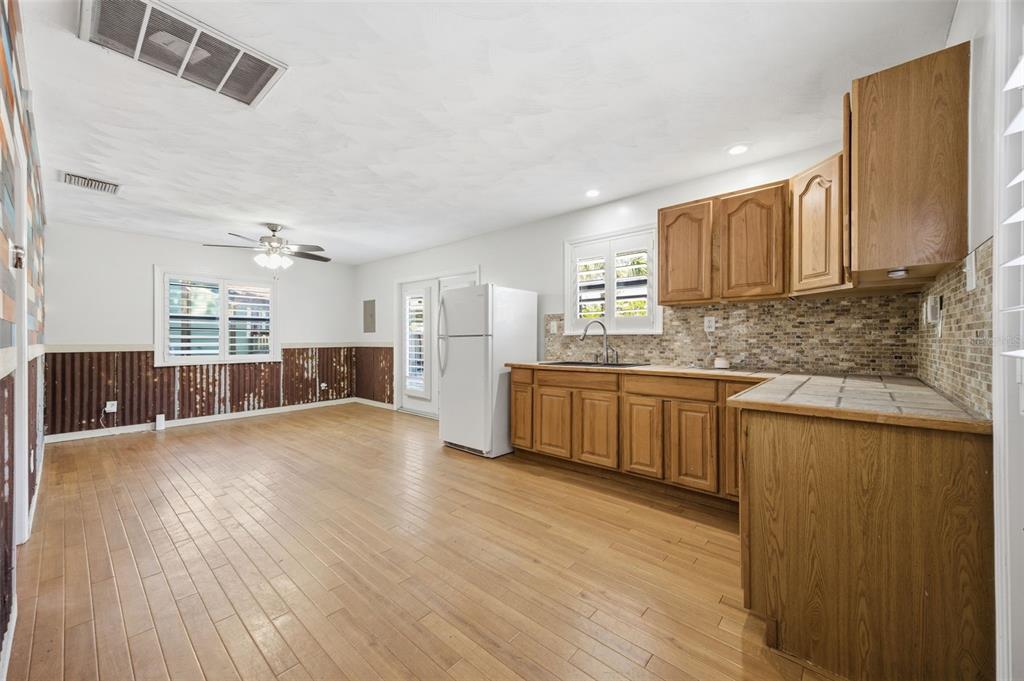 3752 Old Keystone Road Tarpon Springs, FL 34688 - Photo 51 of 71 a large kitchen with stainless steel appliances granite countertop a lot of counter space and wooden floors