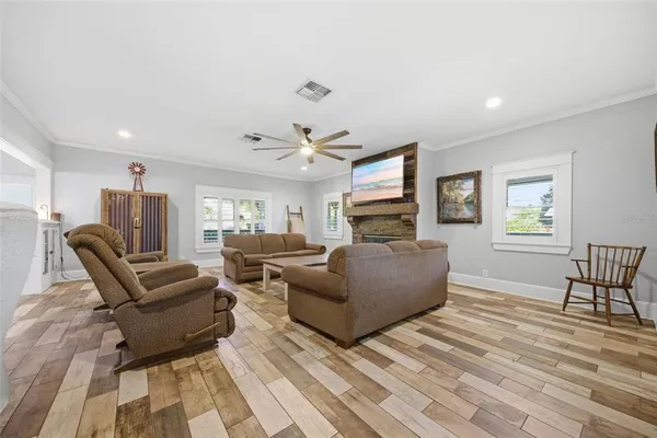 a living room with furniture a dining table and a window