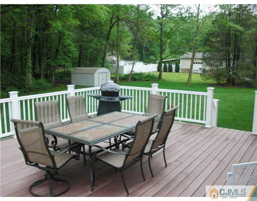 39 Haypress Road Dayton, NJ 08810 - Photo 2 of 11 a view of a table and chairs on the roof deck