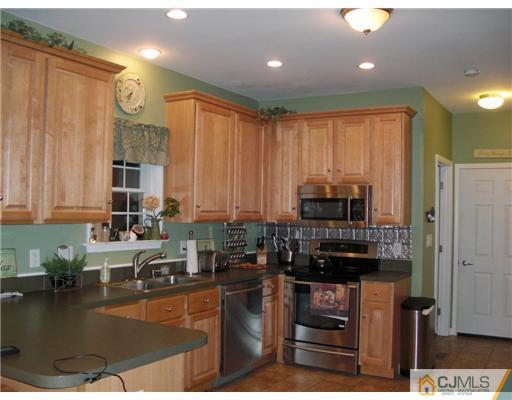 39 Haypress Road Dayton, NJ 08810 - Photo 3 of 11 a kitchen with kitchen island granite countertop a refrigerator stove and sink