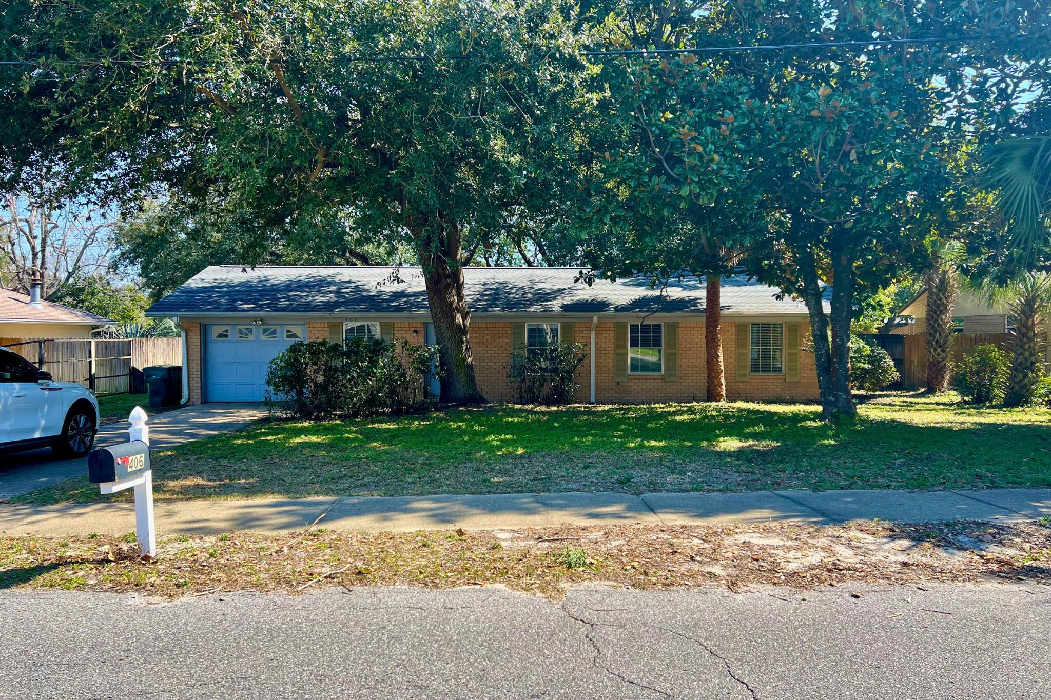 406 Spring Lane Destin, FL 32541 - Photo 2 of 25 a front view of a house with a garden
