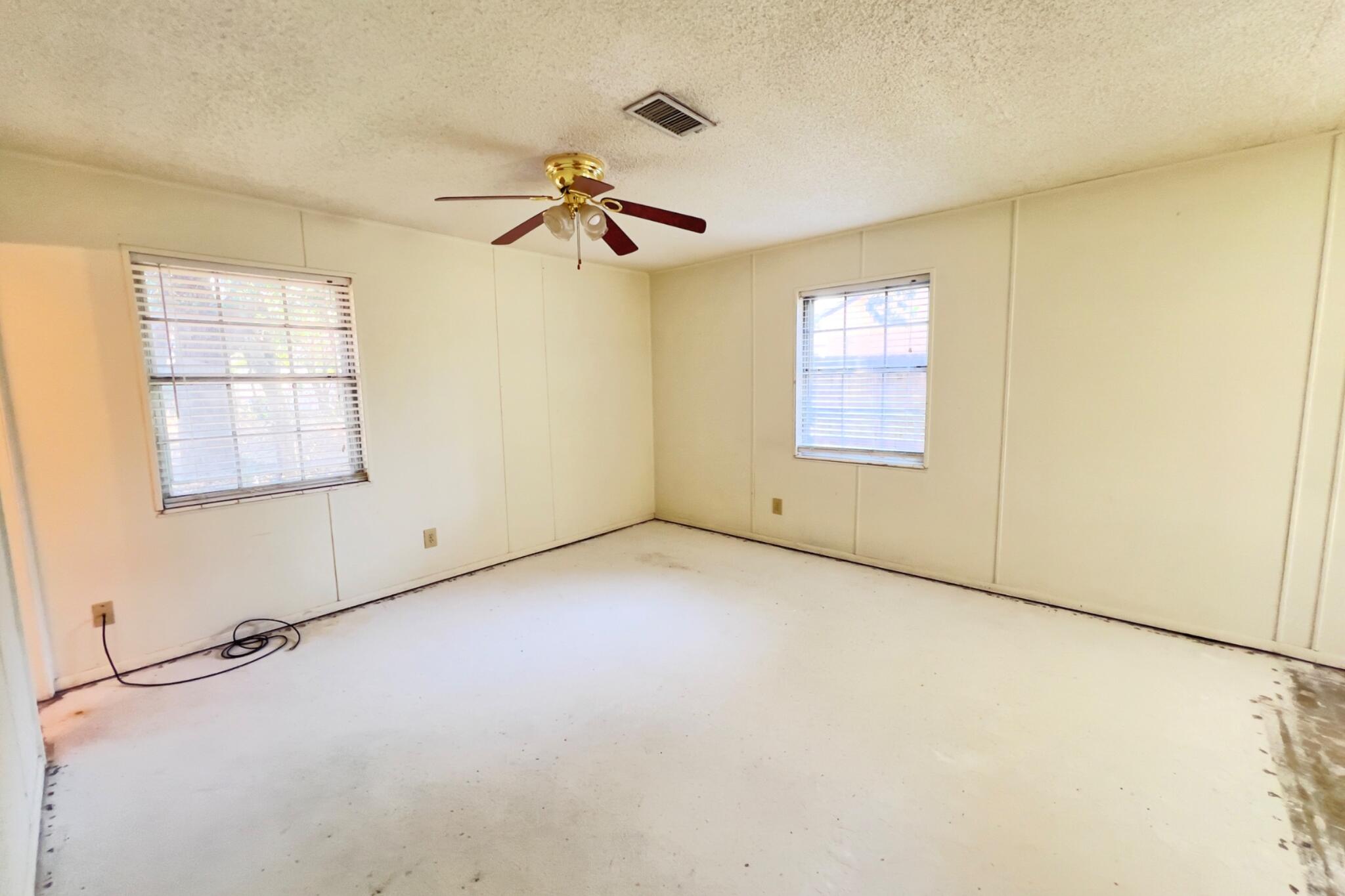 406 Spring Lane Destin, FL 32541 - Photo 21 of 25 an empty room with windows and fan