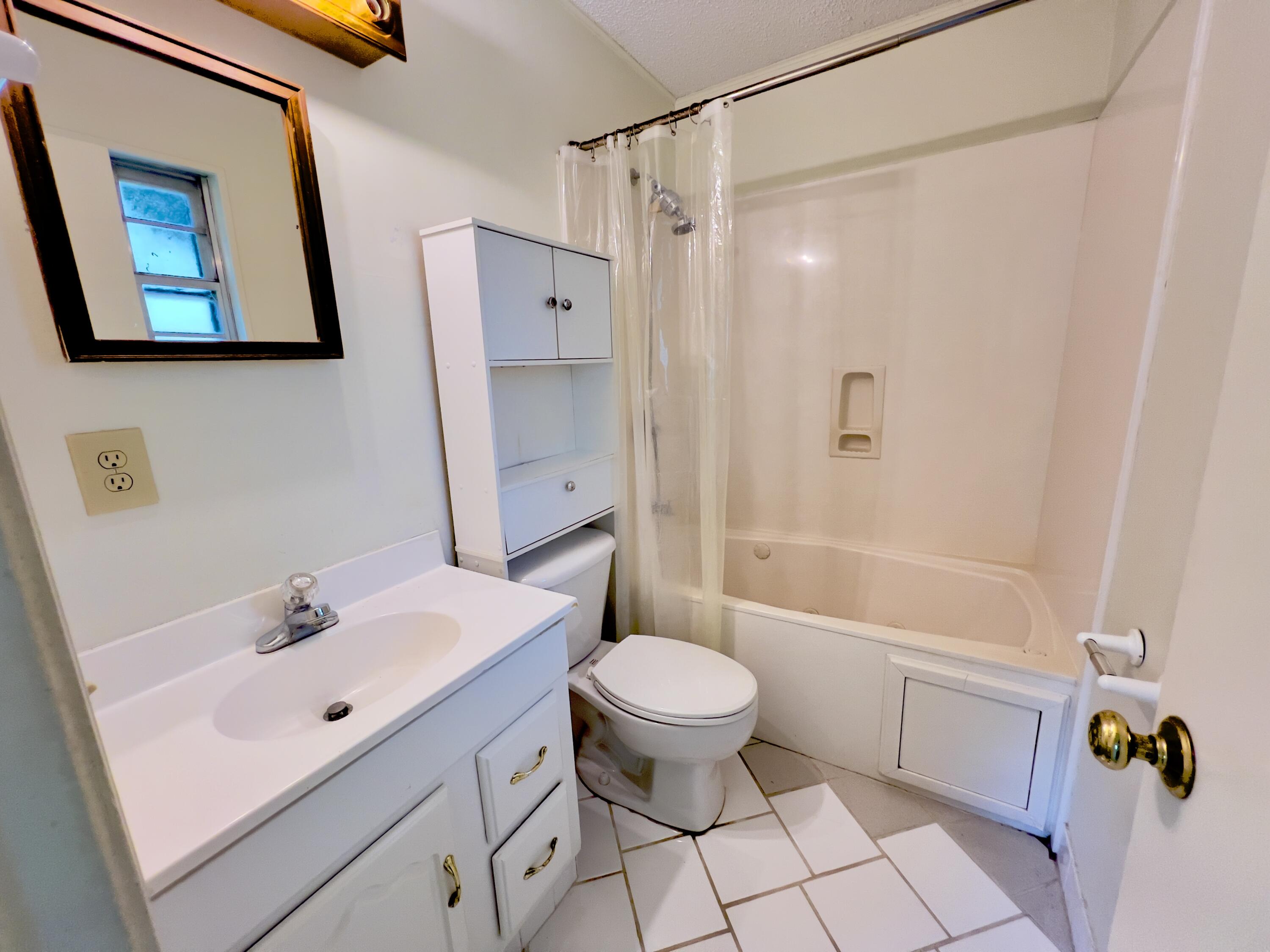 406 Spring Lane Destin, FL 32541 - Photo 22 of 25 a bathroom with a sink toilet and shower