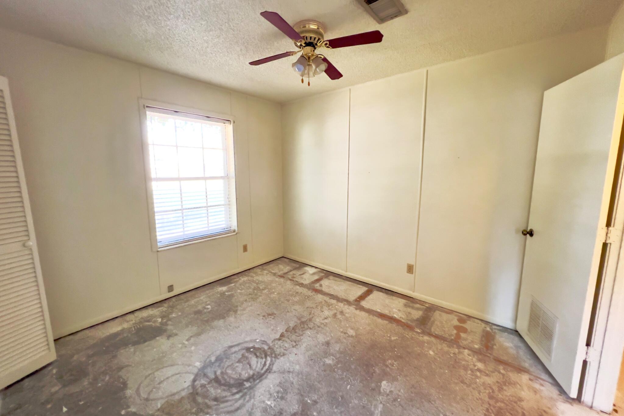 406 Spring Lane Destin, FL 32541 - Photo 23 of 25 wooden floor in an empty room with a window