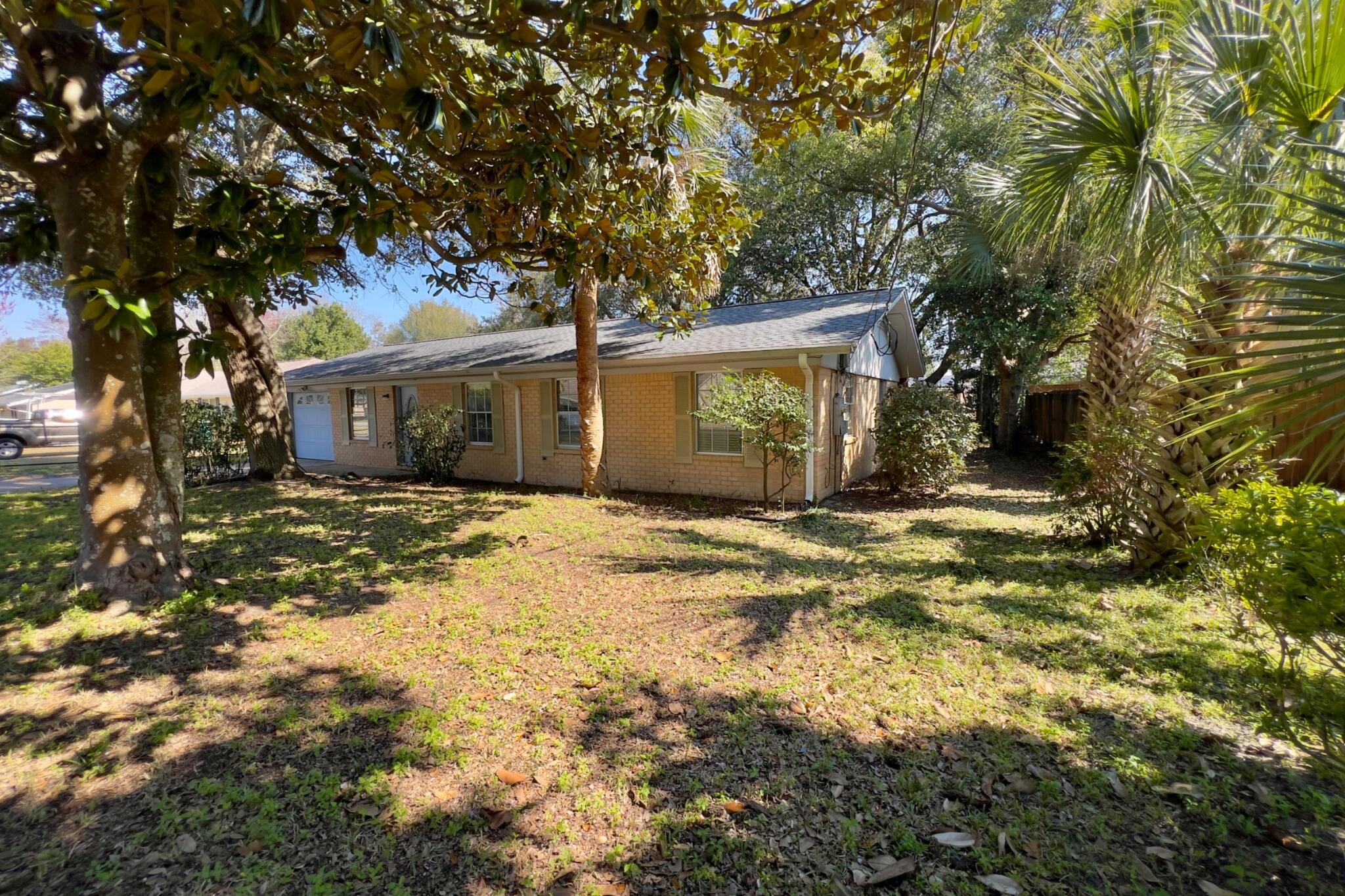 406 Spring Lane Destin, FL 32541 - Photo 3 of 25 a house with trees in front of it