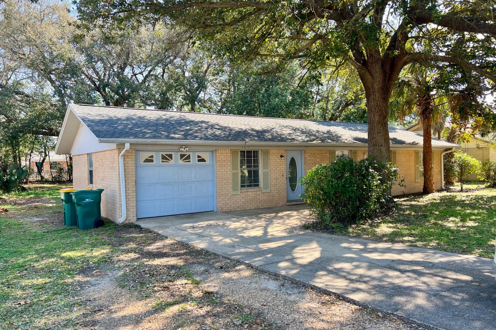 406 Spring Lane Destin, FL 32541 - Photo 4 of 25 a front view of a house with a garden