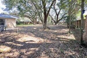 406 Spring Lane Destin, FL 32541 - Photo 5 of 25 a view of a yard with plants and trees