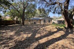 406 Spring Lane Destin, FL 32541 - Photo 6 of 25 a view of a yard in front of a house with large trees