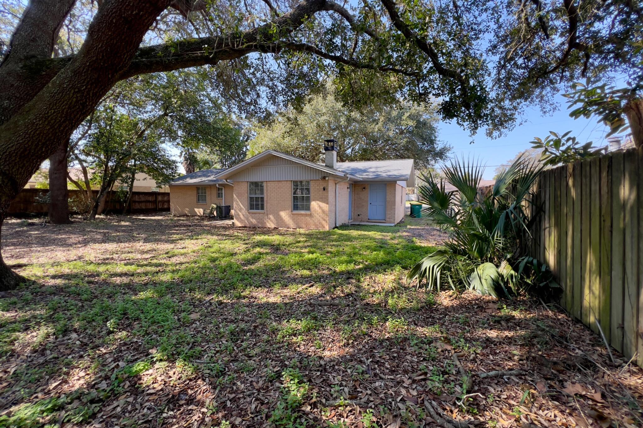 406 Spring Lane Destin, FL 32541 - Photo 8 of 25 a front view of a house with garden