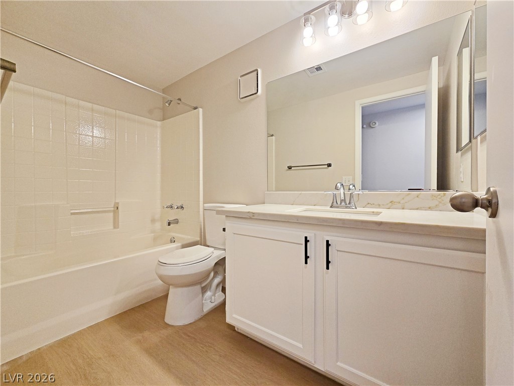 5370 Runningbrook Road Las Vegas, NV 89120 - Photo 18 of 30 A well-lit bathroom features a spacious vanity and a combination shower-tub for daily rejuvenation.