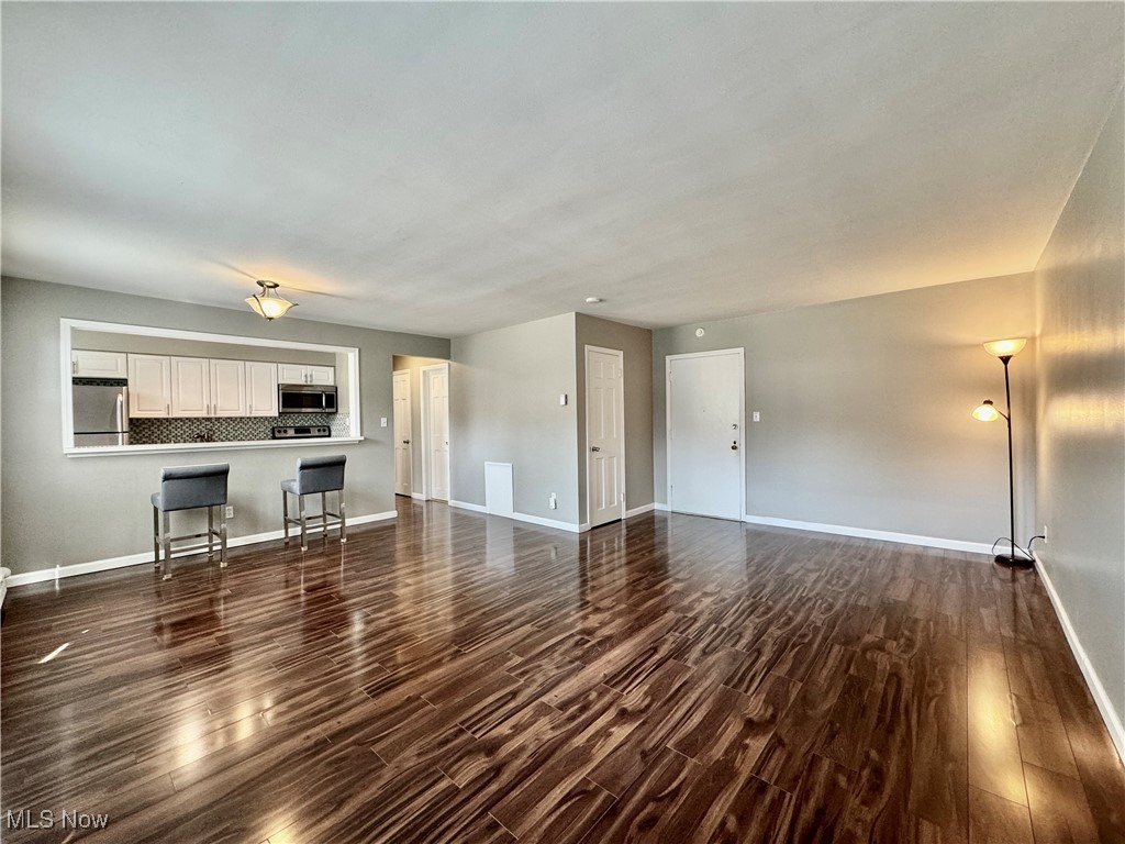 13805 Cedar Road, Unit 103C Cleveland, OH 44118 - Photo 3 of 18 Unfurnished living room with dark wood-style floors