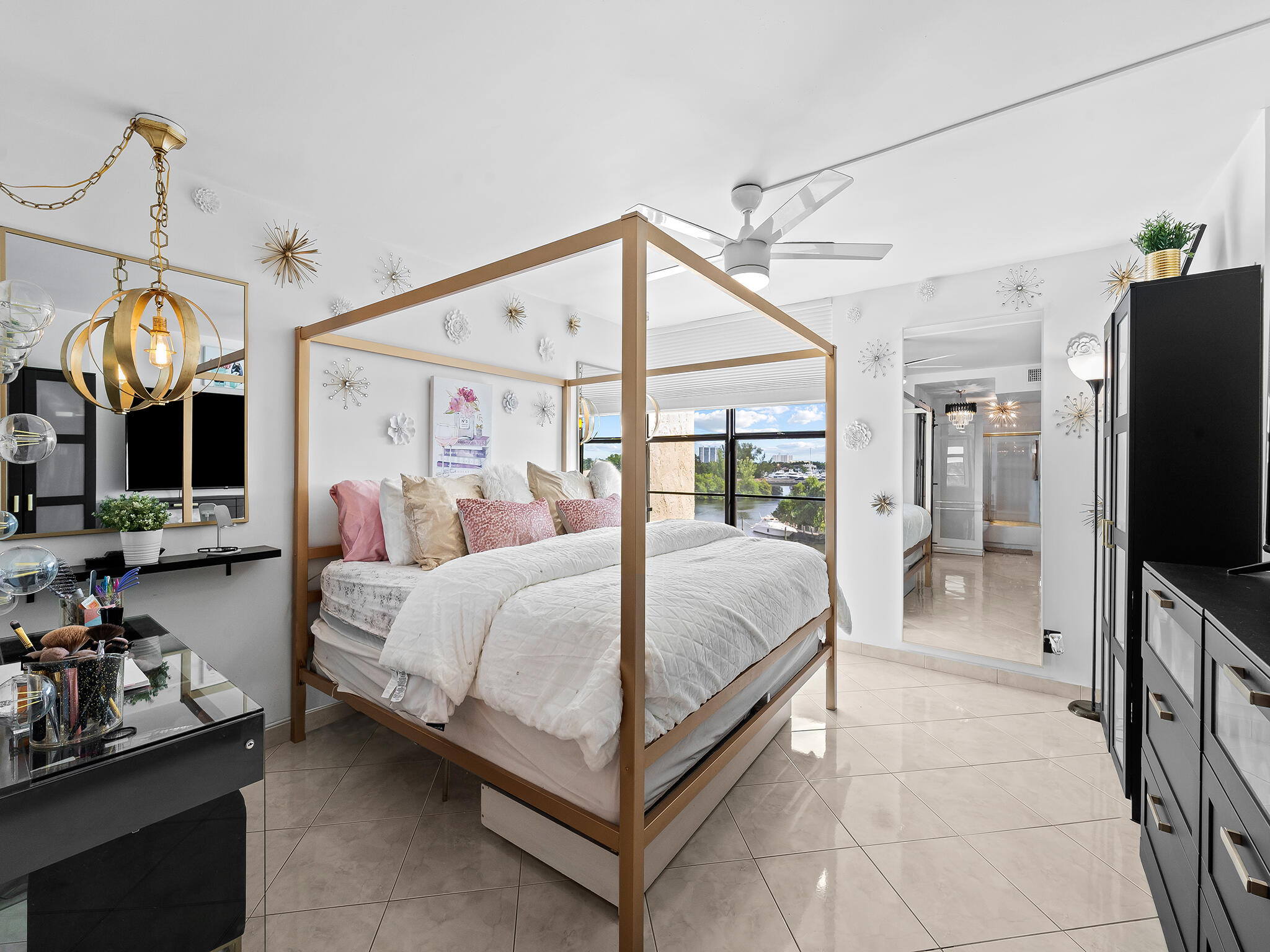 13 Royal Palm Way, Unit 5030 Boca Raton, FL 33432 - Photo 11 of 15 a spacious bedroom with a bed mirror and a flat tv screen on the dresser