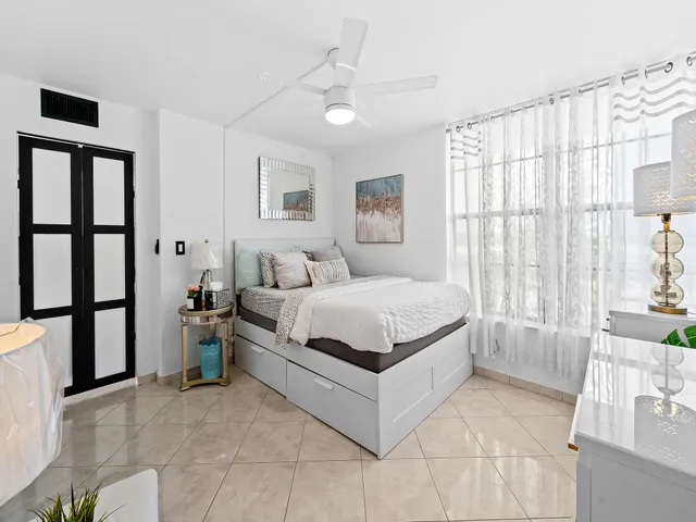 a bedroom with a large bed and a window