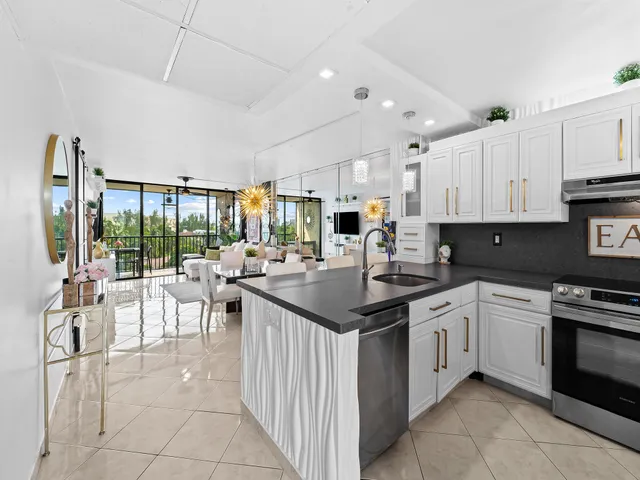 a kitchen with appliances a sink and cabinets