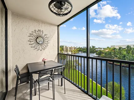 a view of a balcony dining table and chairs