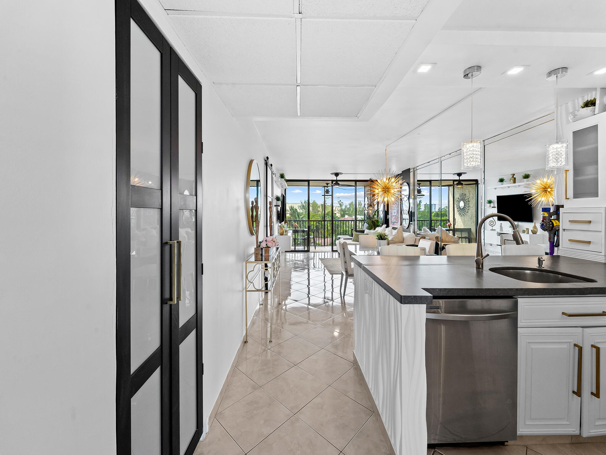 13 Royal Palm Way, Unit 5030 Boca Raton, FL 33432 - Photo 5 of 15 a kitchen with stainless steel appliances kitchen island granite countertop a sink and cabinets