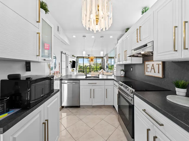 a kitchen with stainless steel appliances granite countertop a sink and cabinets