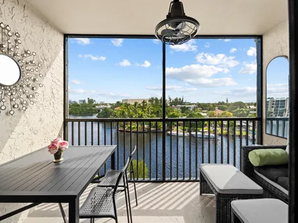 a view of a balcony with furniture and wooden floor