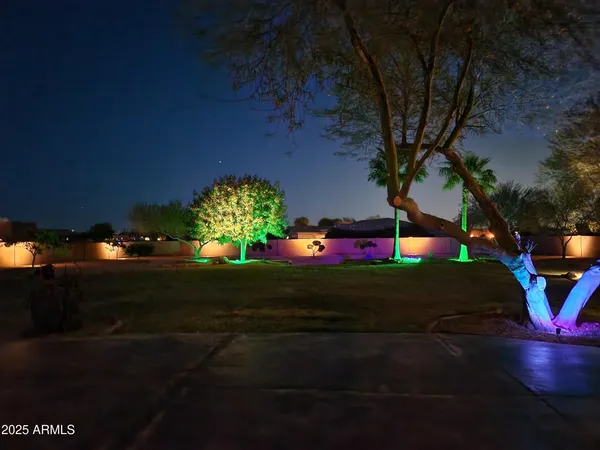 a backyard of a house with lots of green space and a fountain