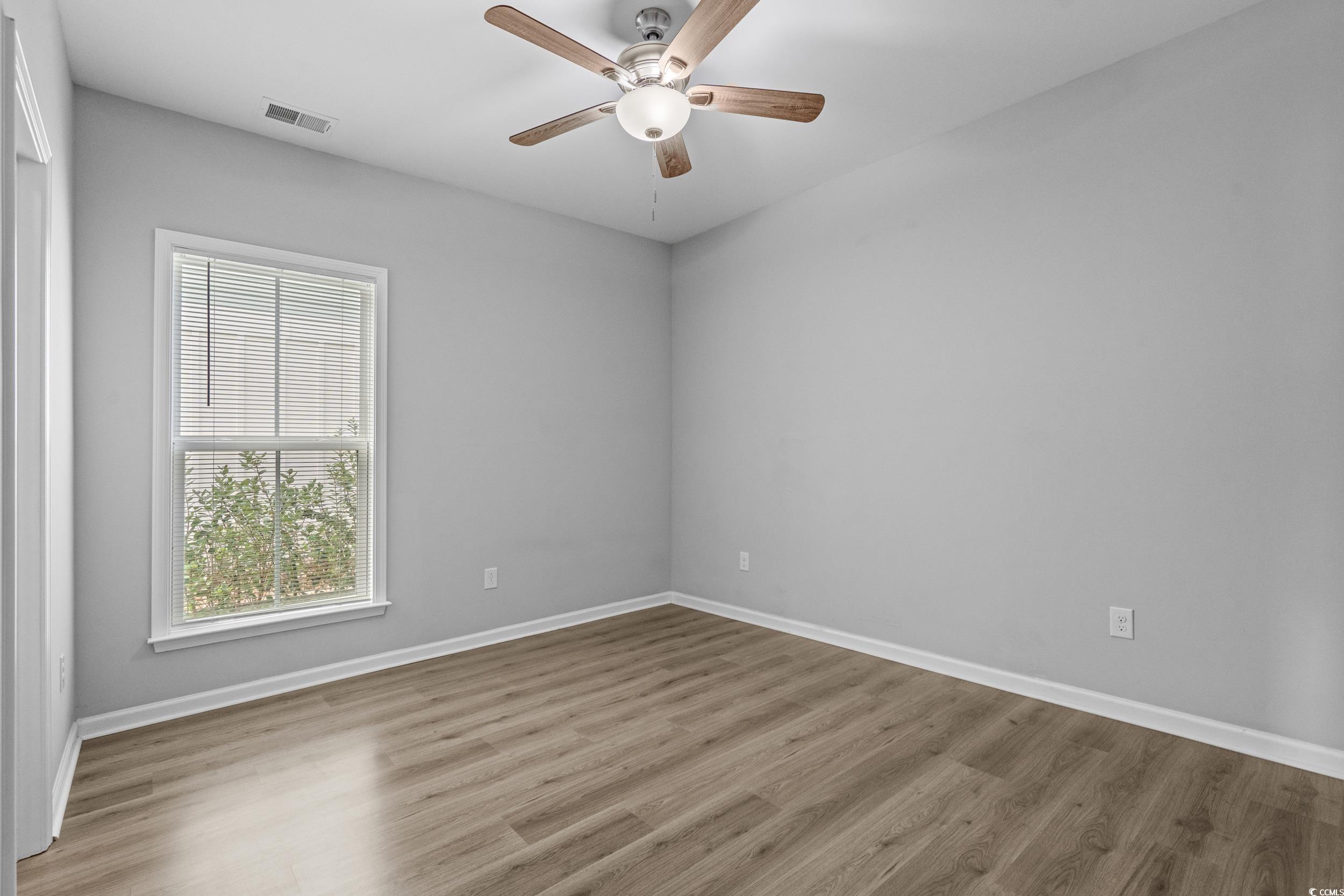 294 Splendor Circle Murrells Inlet, SC 29576 - Photo 29 of 40 Empty room with wood finished floors and a ceiling fan